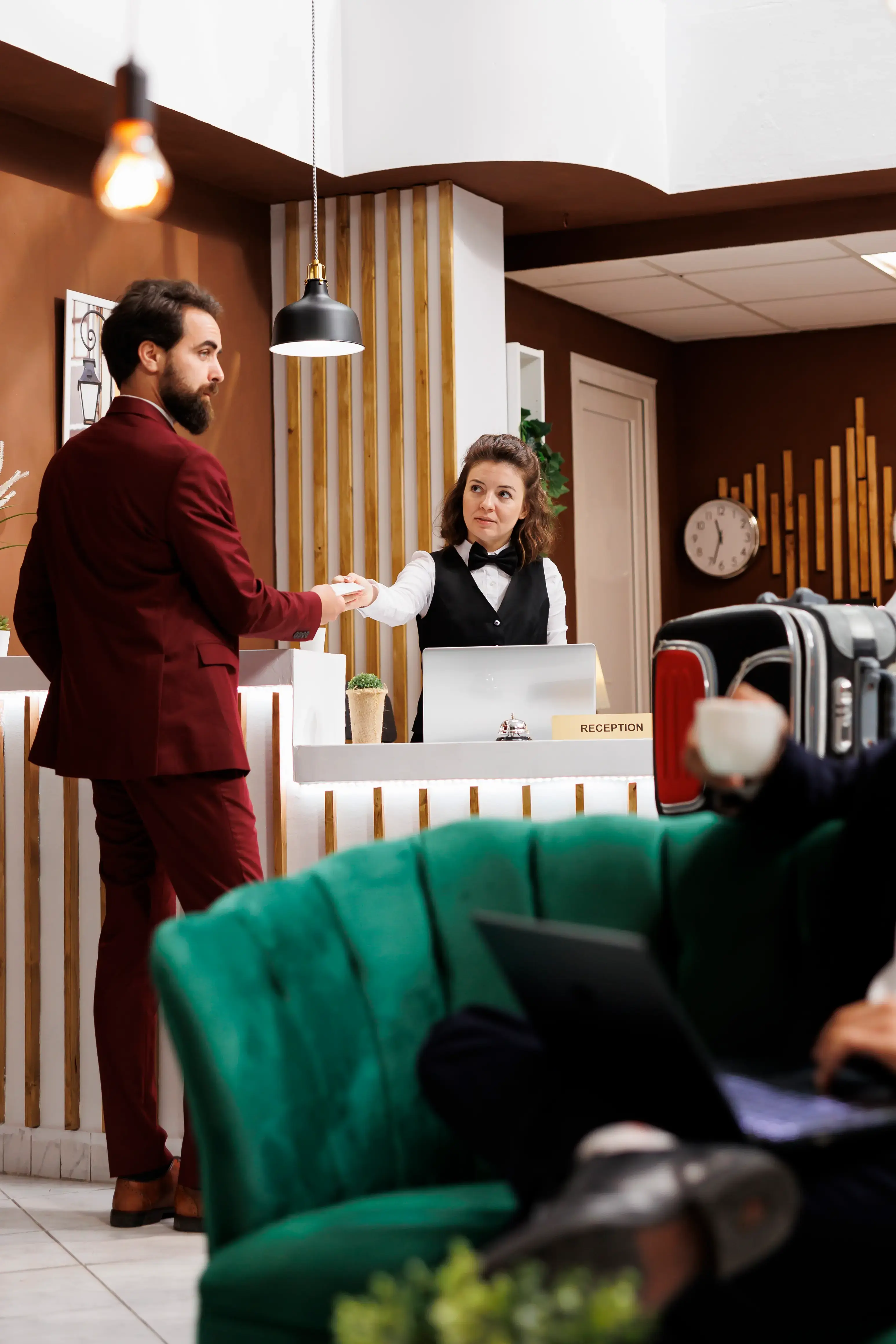 Hotel concierge helping a guest at the front desk